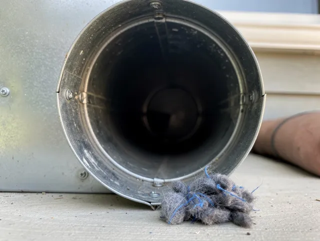 Deerfield Beach Dryer Vent Cleaning technician using specialized equipment to clear severe dryer vent blockage in Deerfield Beach